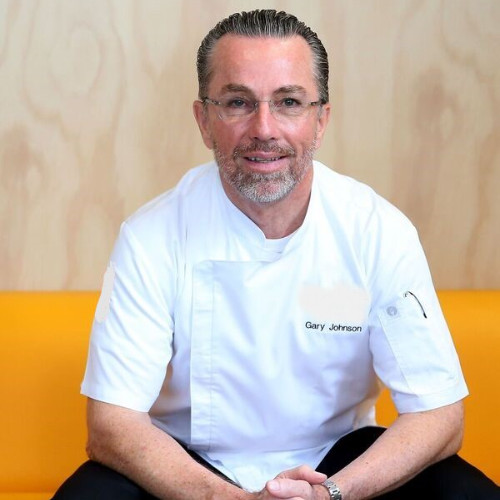 Chef sitting on a couch in a professional pose